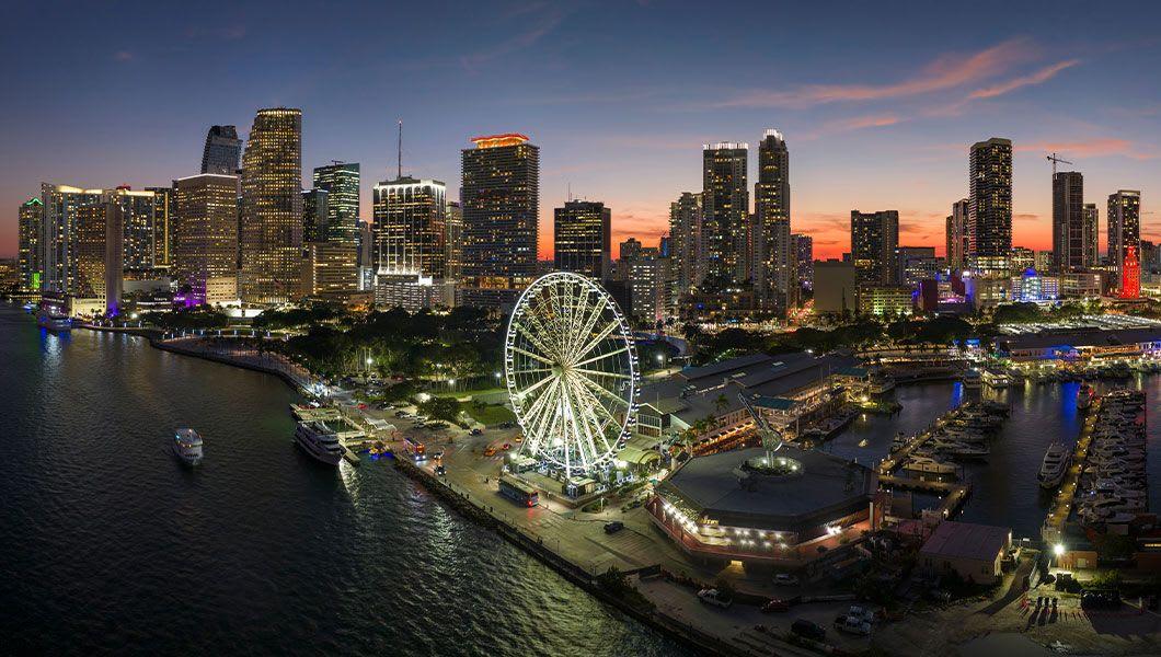 Skyviews-Miami-Observation-Wheel-at-Bayside-Marketplace-with-reflections-in-Biscayne-Bay-and-urban-landscape-at-night.jpg
