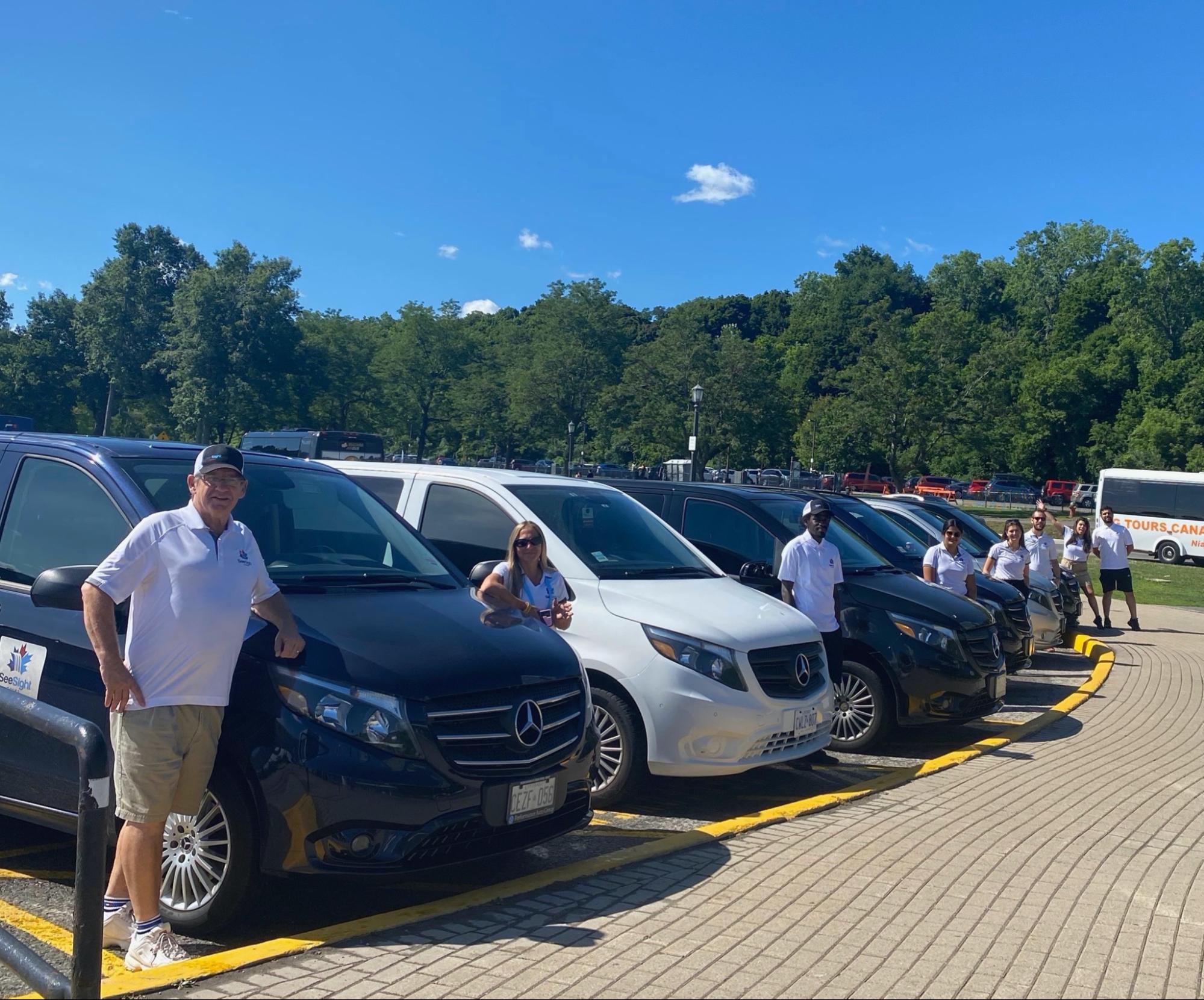 Tour guides standing with their cars