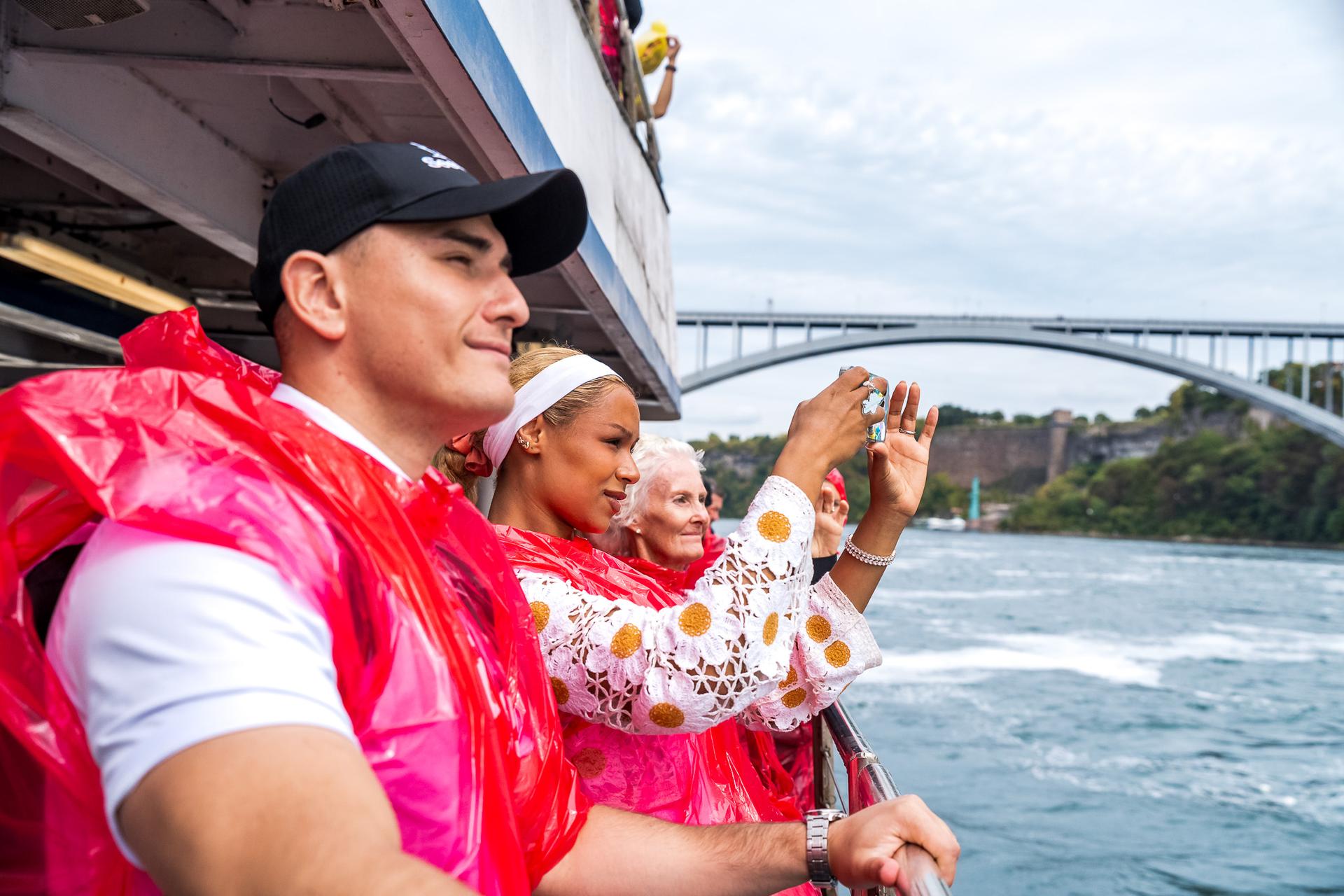 Guide and guests admire the American Falls aboard the Hornblower in Niagara Falls.