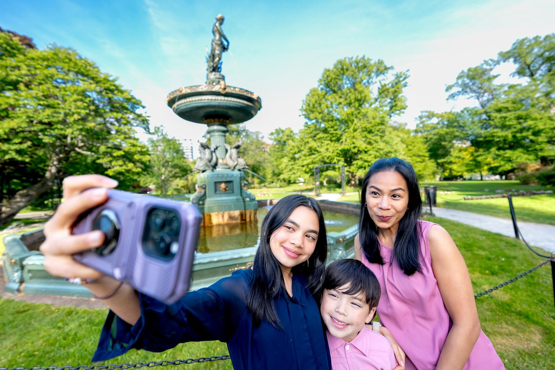 Guests take a selfie at the fountain in the Halifax Public Gardens